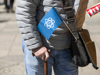 A man attending the 'March for Science' holds a flag with the symbol of the event in Berlin, Germany on April 22, 2017. Thousands of people...