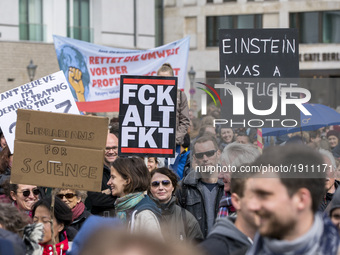 People attending the 'March for Science' hold banners reading 'fck alt fct' and 'Einstein was a refugee' in Berlin, Germany on April 22, 201...