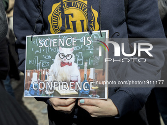 A woman attending the 'March for Science' holds a banner reading 'science is confidence' in Berlin, Germany on April 22, 2017. Thousands of...
