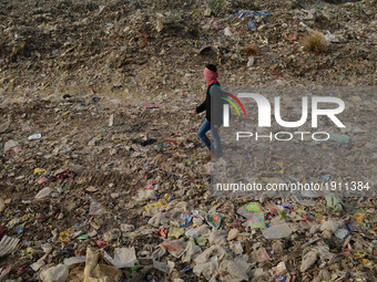 An indian youth passes by a huge garbage dump yard ,  on World Earth Day , in Allahabad on April 22,2017. Earth Day is an annual event celeb...
