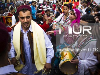 Artists perform with drums as they march at the opening ceremony of the 5th International Festival for Drums and Traditional Arts in El Moez...