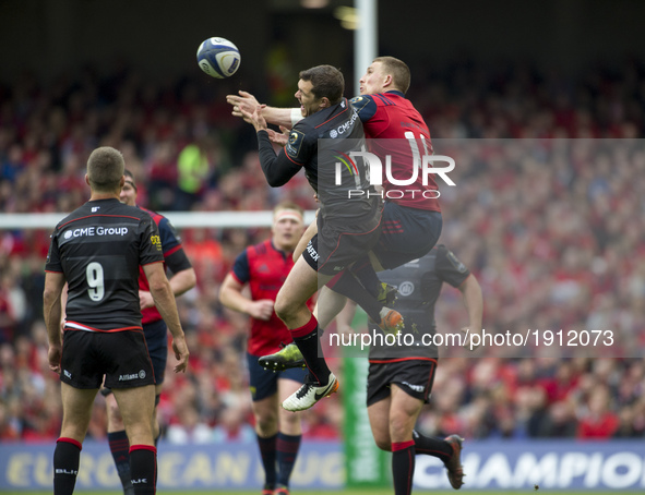 Andrew Conway of Munster jumps for the ball with Alex Goode of Saracens during the European Rugby Champions Cup Semi-Final match between Mun...