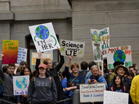 Protestors hold up signs opposing conservative standpoints of the Trump-Administration regarding science and the environment. Thousands part...