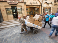 A man carried packs on Al Muezz street in Cairo, Egypt, 22 April 2017. (