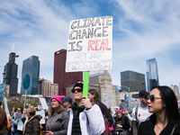 People display signs during the March for Science in Chicago on April 22, 2017. Held on Earth Day, the March for Science was held in support...