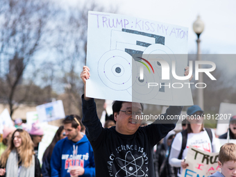 People display signs during the March for Science in Chicago on April 22, 2017. Held on Earth Day, the March for Science was held in support...