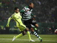Benfica's Brazilian goalkeeper Ederson Moraes (L) vies with Sporting's forward Bas Dost during the Portuguese League  football match between...