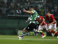Sporting's midfielder Adrien Silva scores a goal during the Portuguese League  football match between Sporting CP and SL Benfica at Jose Alv...
