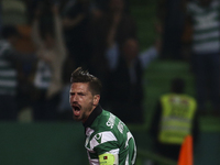 Sporting's midfielder Adrien Silva celebrates after scoring a goal during the Portuguese League  football match between Sporting CP and SL B...