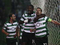 Sporting's midfielder Adrien Silva (R) celebrates with Sporting's midfielder William Carvalho after scoring a goal during the Portuguese Lea...