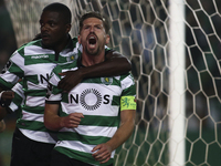 Sporting's midfielder Adrien Silva (R) celebrates with Sporting's midfielder William Carvalho after scoring a goal during the Portuguese Lea...