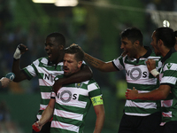 Sporting's midfielder Adrien Silva (2ndR) celebrates with team mates after scoring a goal during the Portuguese League  football match betwe...