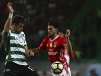 Benfica's forward Luis Fernandes 'Pizzi' (R) vies with Sporting's defender Sebastian Coates during the Portuguese League  football match bet...