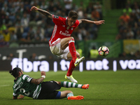 Benfica's Swedish defender Victor Lindelof (R) vies with Sporting's midfielder Ezequiel Schelotto during the Portuguese League  football mat...