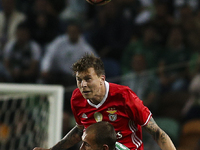 Benfica's Swedish defender Victor Lindelof (up) vies with Sporting's forward Bas Dost during the Portuguese League  football match between S...