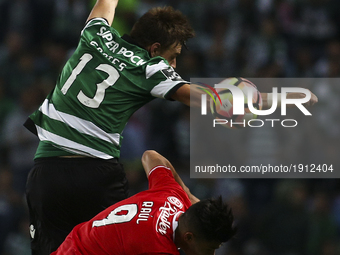 Sporting's defender Sebastian Coates (L) vies with Benfica's Mexican forward Raul Jimenez during the Portuguese League  football match betwe...