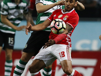Sporting's defender Jefferson (L) vies for the ball with Benfica's forward Eduardo Salvio (R)  during Premier League 2016/17 match between S...
