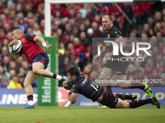 Simon Zebo of Munster tackled by Brad Barritt of Saracens during the European Rugby Champions Cup Semi-Final match between Munster Rugby and...