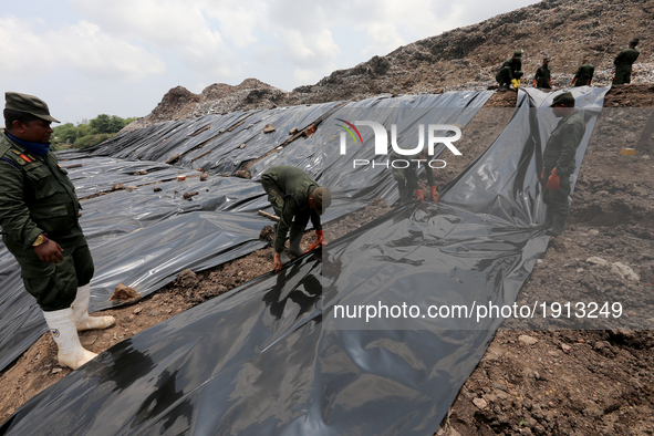  Sri Lanka Army  personnel cover   the site of the collapsed garbage mountain with black colored polythene at Meetotamulla, in Colombo, Sri...