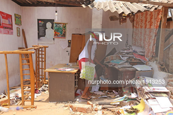 A Sri Lankan garbage collapse survivor searches for documents among the debris of his damaged house in Meetotamulla, on the outskirts of Col...