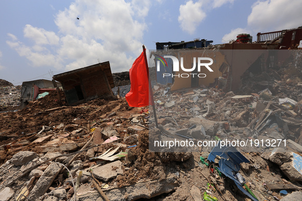 A Red flag that demarcate danger zones is seen among the debris of damaged houses days after the collapse of a garbage mound in Meetotamulla...