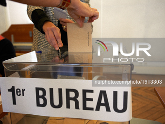 A woman cast her vote at the Capitole's polling station for the first round of the French presidential election,  Toulouse,  France,  April...