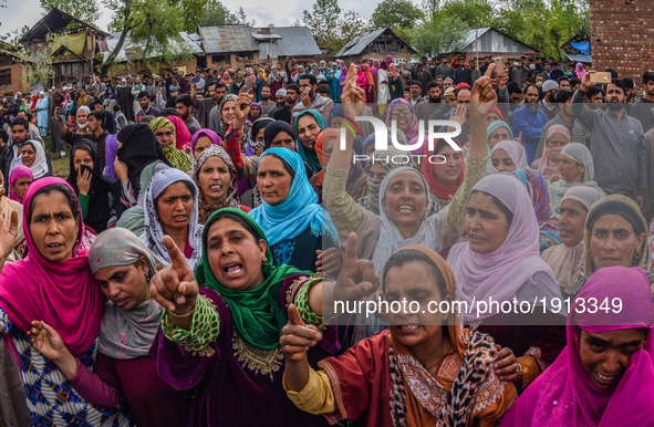 Kashmiri Muslim women shout anti Indian and pro Kashmir freedom slogans as they attend the funeral procession of   Younis Maqbool Ganie, a p...