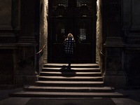 Woman walks into church in Lviv on April 21, 2017.  Lviv is the largest city in western Ukraine and the seventh largest city in the country...