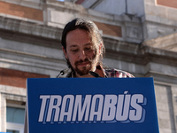 Left-wing party Podemos leader Pablo Iglesias speaks as the 'Tramabus,' an anti-corruption bus belonging to the Spanish opposition party Pod...