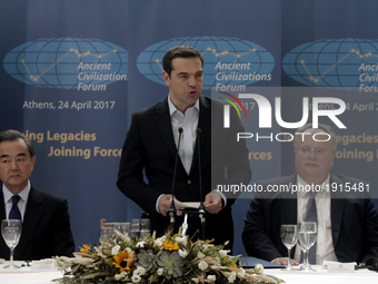 Greek Prime Minister Alexis Tsipras (C) delivers a speech  during the 
