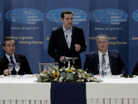Greek Prime Minister Alexis Tsipras (C) delivers a speech  during the 