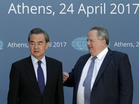Chinese Foreign Minister Wang Yi  (L) with his Greek counterpart Nikos Kotzias, pose for a picture during the 