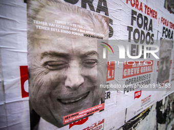 Posters with the face of President Michel Temer summon Brazilians, in Sao Paulo, on April 24, 2017 to a general strike next Friday, April 28...
