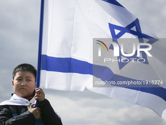 South Korea boy holds a flag of Israel during the 'March of the Living' at the former Nazi-German Auschwitz Birkenau concentration and exter...