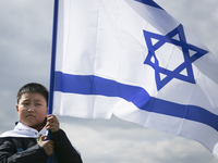 South Korea boy holds a flag of Israel during the 'March of the Living' at the former Nazi-German Auschwitz Birkenau concentration and exter...
