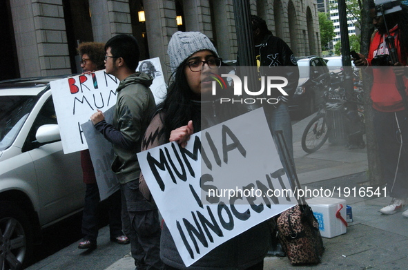 A demonstrator holds a sign declaring the innocence of Mumia Abu-Jamal outside of the Criminal Justice Center in Philadelphia, PA on April 2...