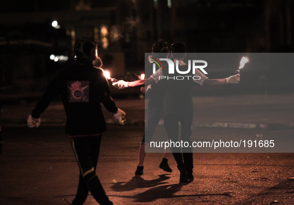 Bahrain , Sitra - protesters holding molotov cocktail during the clashes , heavy clashes between protesters and riot police after suppressin...
