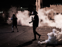Bahrain , Sitra - protesters takign a part during the clashes , heavy clashes between protesters and riot police after suppressing a peacefu...
