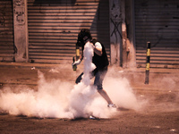 Bahrain , Sitra - protester ready to return tear gas canister , heavy clashes between protesters and riot police after suppressing a peacefu...