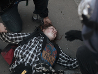 A young protester is quickly assisted after she fell and hurt herself during a panic moment where police forces tried to disperse the protes...
