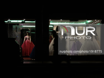 Palestinians walk through a wedding dress shop during a power outage in northern Gaza City, 25 April 2017. Most Palestinians in the Gaza Str...