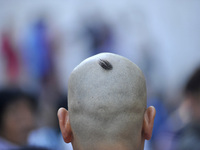 Nepalese Devotee shave his head for the ritual procession for the Mother's Day celebration at Matatritha temple in Kathmandu, Nepal on Wedne...