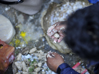 Nepalese Devotees making offering of beaten rice for the procession of the Mother's Day celebration at Matatritha temple in Kathmandu, Nepal...