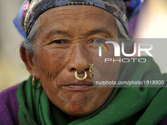 A Portrait of an old woman from Tamang community in a traditional attire and ornaments arrives to offer ritual puja at Matatritha temple in...