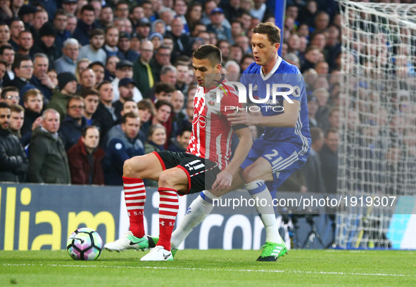 Southampton's Dusan Tadic holds of Chelsea's Nemanja Matic during the Premier League match between Chelsea and Southampton at Stamford Bridg...