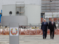 President of Ukraine Petro Poroshenko (R) and Belarus Alexander Lukashenko (L) walk in front of the Chornobyl NPP newly raised safe confinem...
