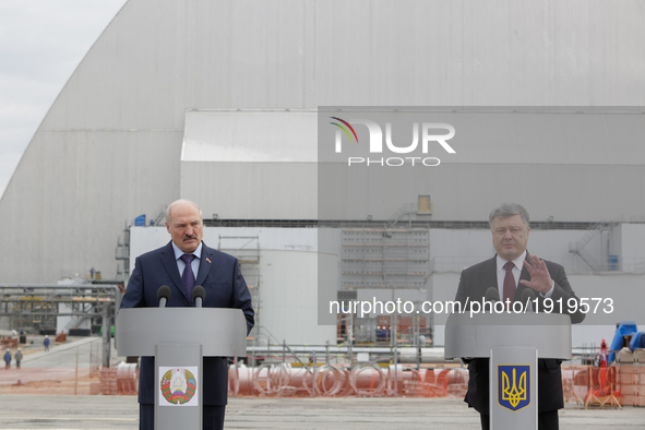 President of Ukraine Petro Poroshenko (R) and Belarus Alexander Lukashenko (L) talk to media in front of the Chornobyl NPP newly raised safe...