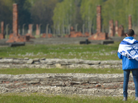 A young man meditates as he walks through the remains of the former camp during the annual March of the Living inside the former German Nazi...