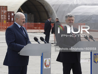 Belarusian President Alexander Lukashenko (L) and Ukrainian President Petro Poroshenko (R) speaks in front the new Safe Confinement over the...