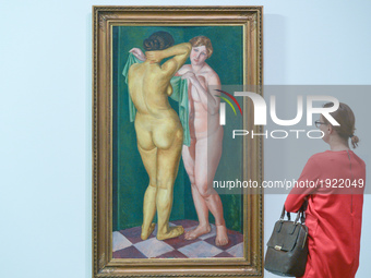 A lady looks at Zbigniew Pronaszko's oil canvas 'Two Nudes Standing' - a part of 'Art in Art' new exhibition that features a wide range of w...